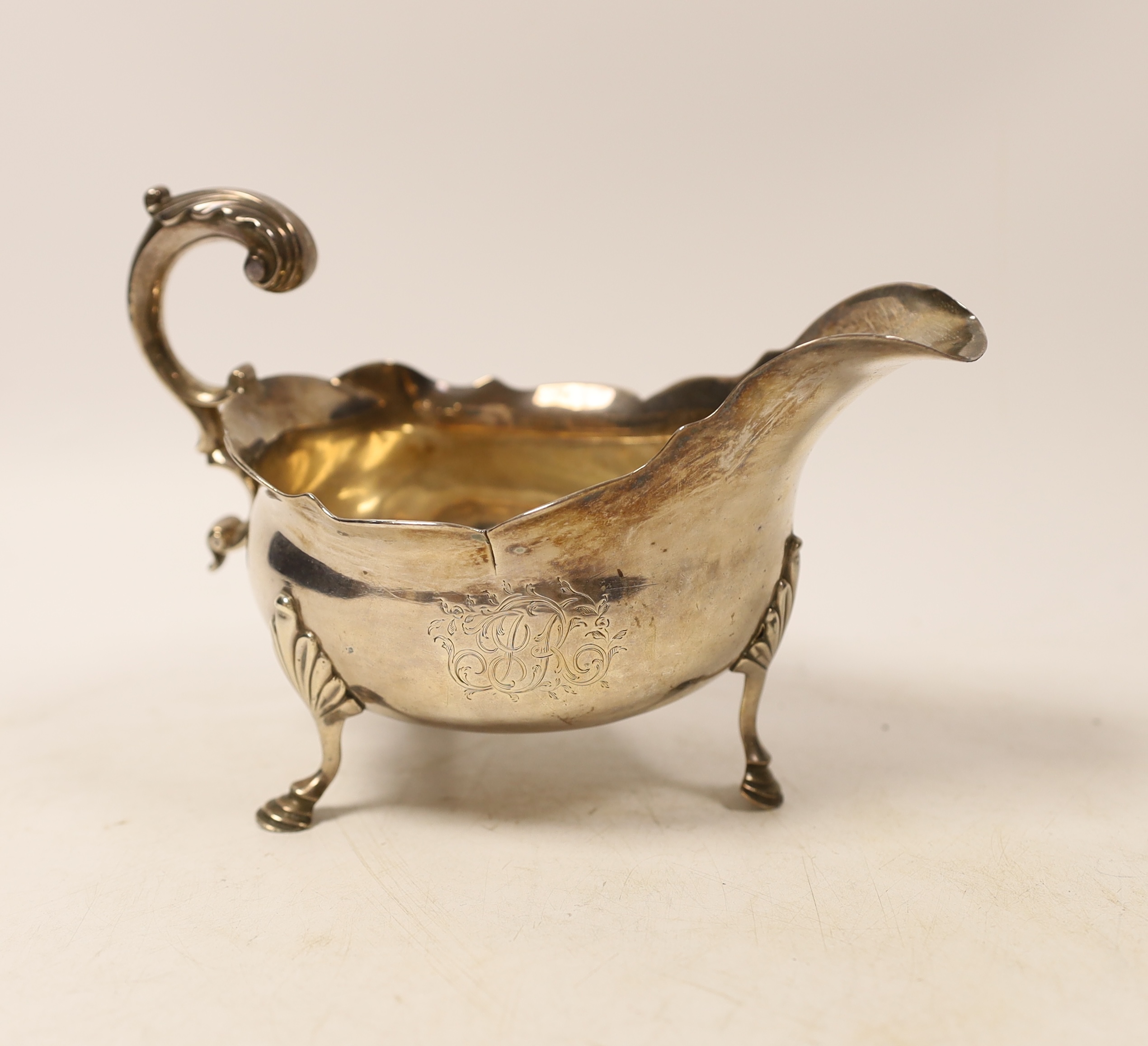 A George III silver sauce boat, with flying scroll handle, George Smith III, London, 1770, length 17.5cm, 9.9oz.